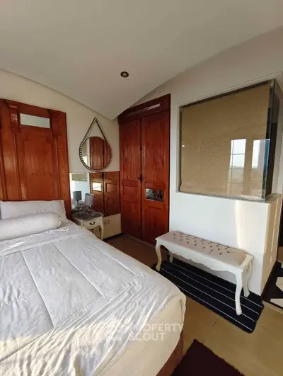 Charming bedroom with elegant wooden accents and cozy decor, perfect for relaxation and comfort.