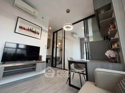 Modern living room with sleek design, featuring a TV, air conditioning, and stylish decor.