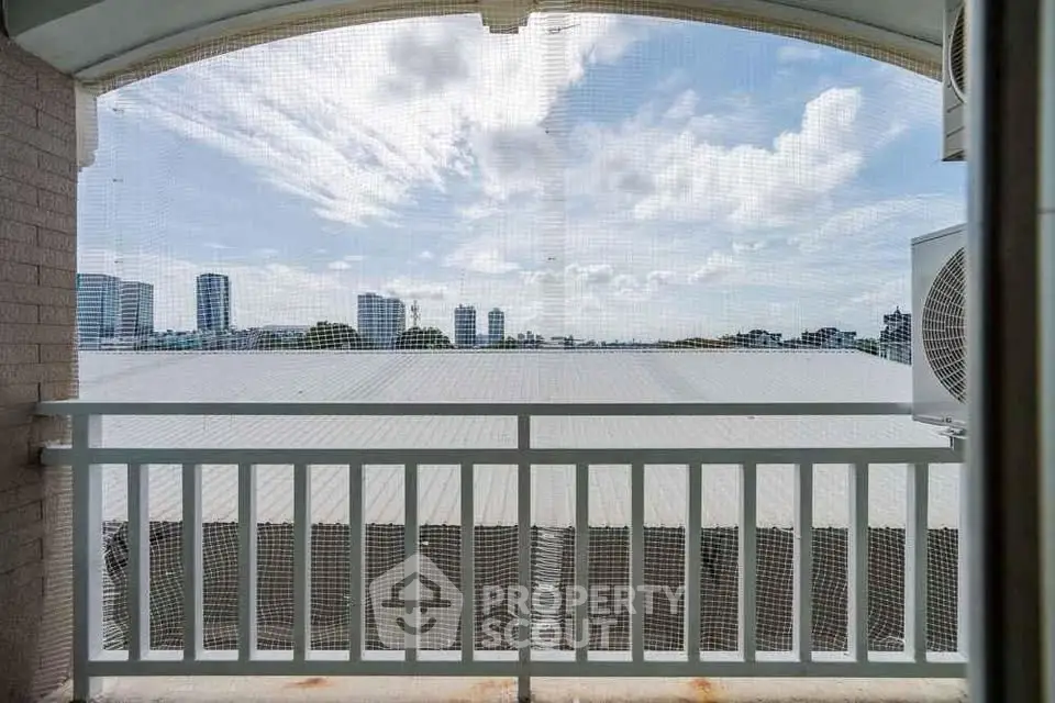 Stunning cityscape view from a balcony with modern railing and expansive skyline.