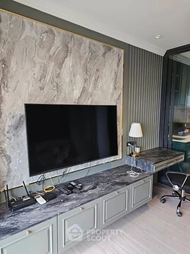 Modern living room with sleek TV setup and elegant marble accents