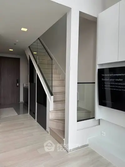 Modern duplex interior with sleek staircase and minimalist design