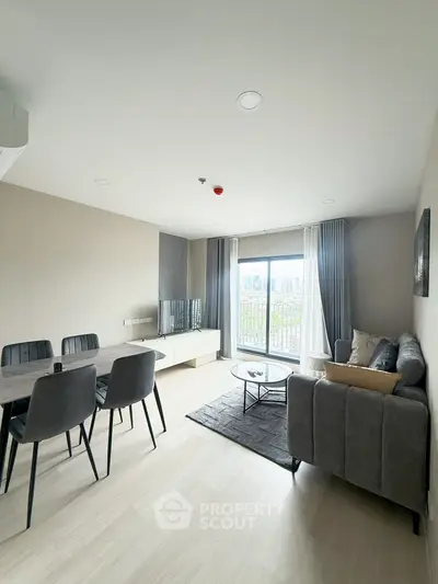 Modern living room with city view, stylish furniture, and natural light.