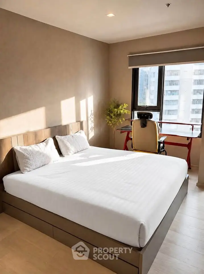 Modern bedroom with large window and study desk, featuring a comfortable bed and natural light.