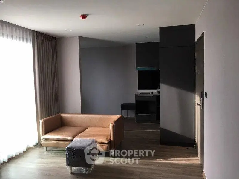 Modern living room with natural light and minimalist furniture in a stylish apartment.