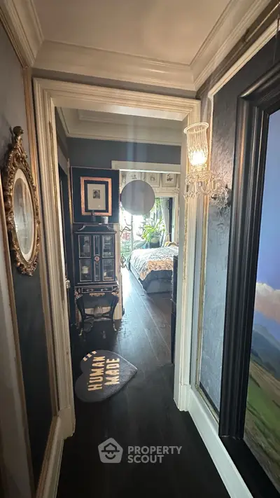 Charming hallway leading to a cozy bedroom with elegant decor and natural light.