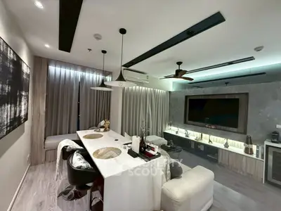 Modern living room with stylish decor and open layout, featuring a sleek dining area and contemporary lighting.