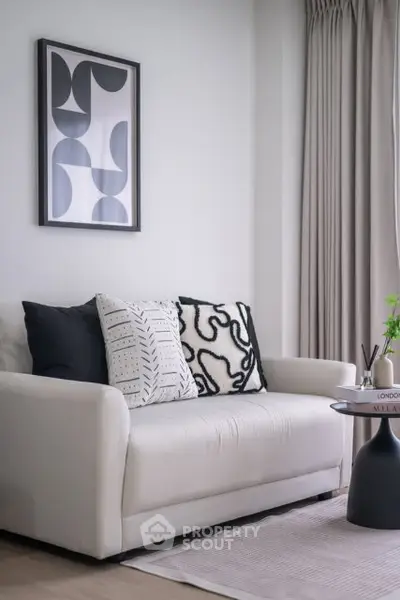 Modern living room with stylish sofa and abstract art, perfect for urban living.