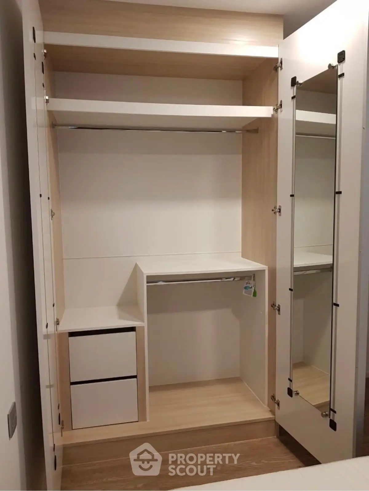 Spacious modern wardrobe with mirror and ample storage space