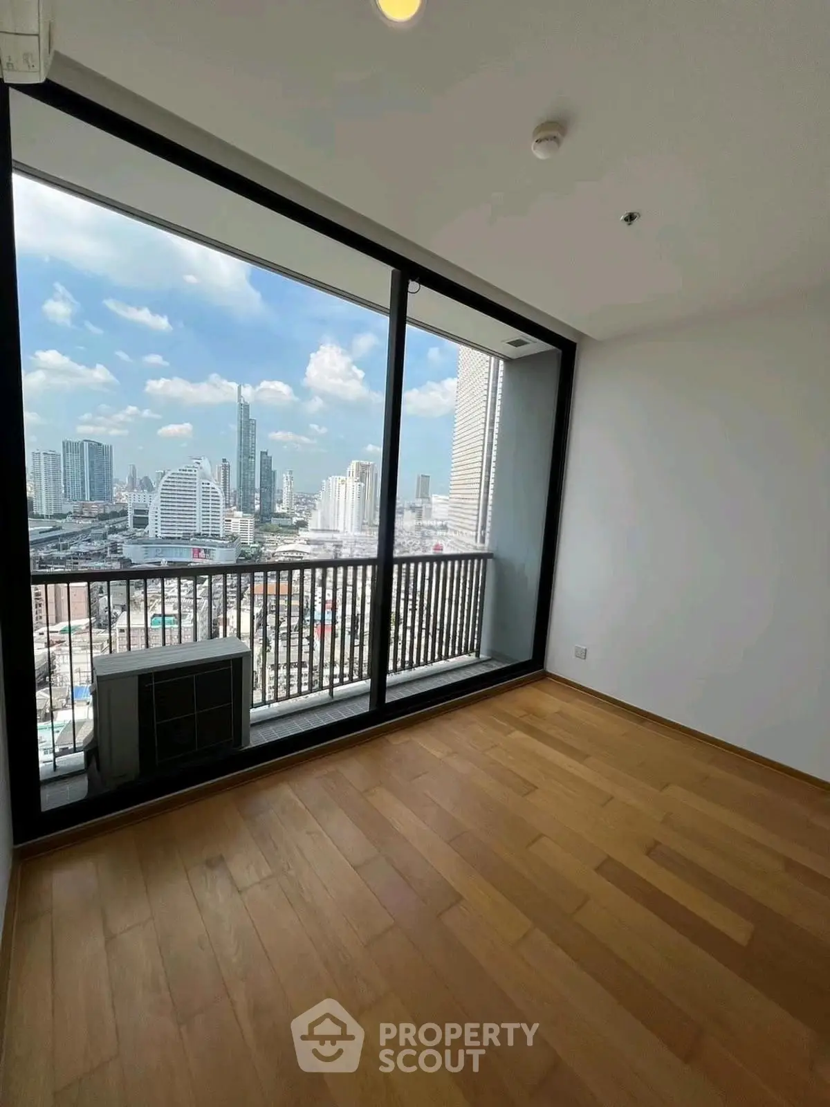 Spacious room with stunning city view and wooden flooring