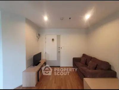 Cozy living room with modern sofa and TV unit, perfect for relaxation.