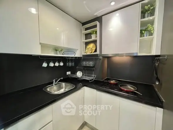 Modern kitchen with sleek black countertops and white cabinets