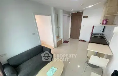 Modern compact living room with kitchenette in a cozy apartment