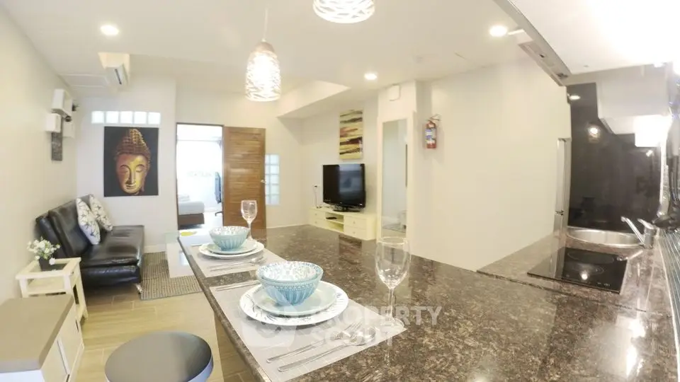 Modern open-plan living room with stylish kitchen and cozy seating area