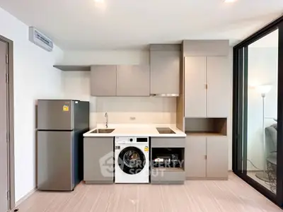 Modern kitchen with sleek cabinetry, integrated appliances, and stylish design in a contemporary apartment.