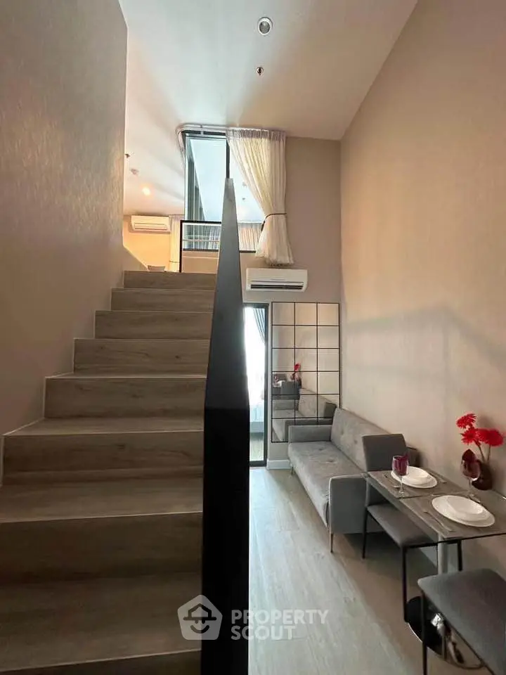Modern duplex apartment with stylish staircase and cozy living area