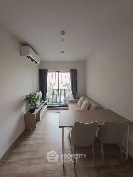 Modern living room with stylish furniture and balcony view, perfect for cozy gatherings.
