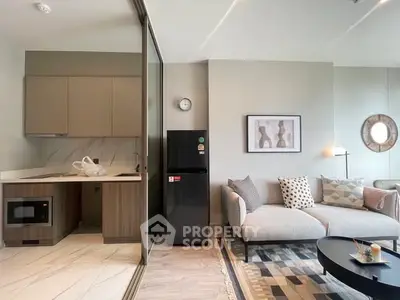 Modern living room with stylish kitchen, featuring sleek appliances and contemporary decor.
