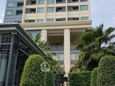 Luxurious high-rise building with lush greenery and modern architecture.