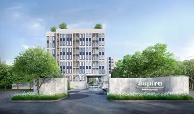 Modern residential building with lush greenery and stylish entrance in urban setting.
