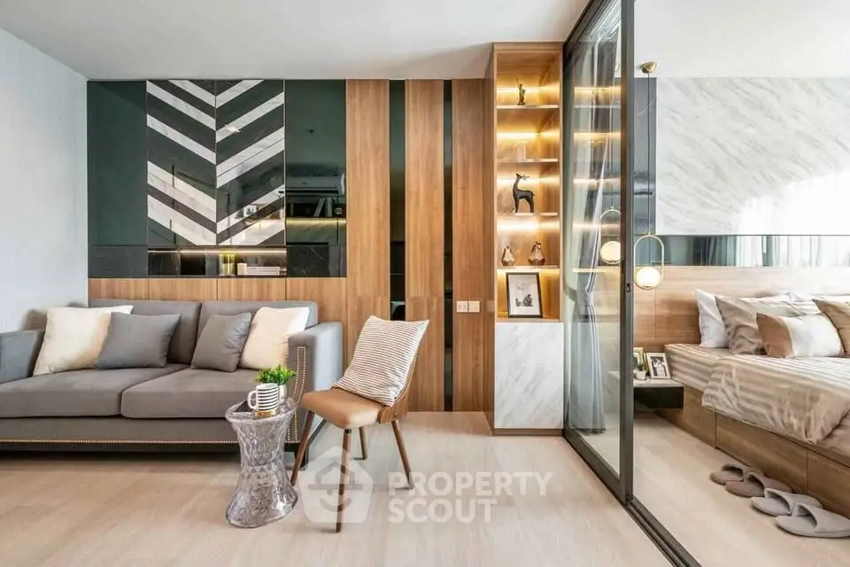 Modern open-concept living room with stylish decor and adjacent bedroom view.