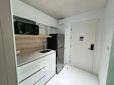 Modern compact kitchen with sleek appliances and minimalist design