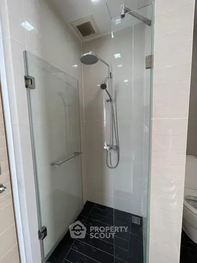 Modern bathroom with glass shower enclosure and sleek fixtures