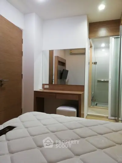 Modern bedroom with ensuite bathroom and stylish wooden furniture