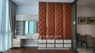 Luxurious bedroom with elegant built-in wardrobe and stylish desk area.