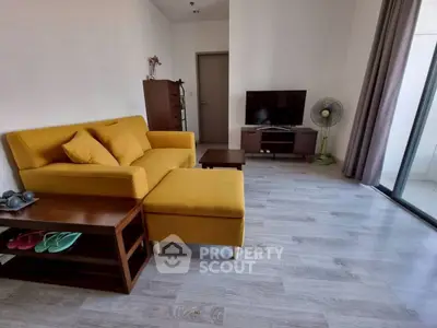 Modern living room with yellow sofa and sleek TV setup, perfect for relaxation.