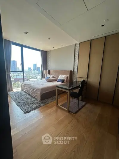 Luxurious bedroom with city view, featuring modern decor and large windows for natural light.