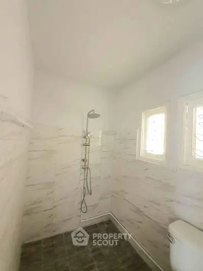 Modern bathroom with marble tiles and sleek shower design