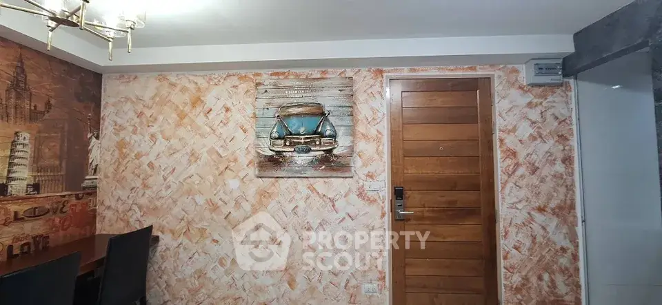 Stylish dining area with artistic wall decor and wooden door, perfect for modern living.