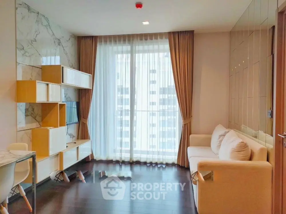 Modern living room with elegant decor and large window view in a high-rise apartment.