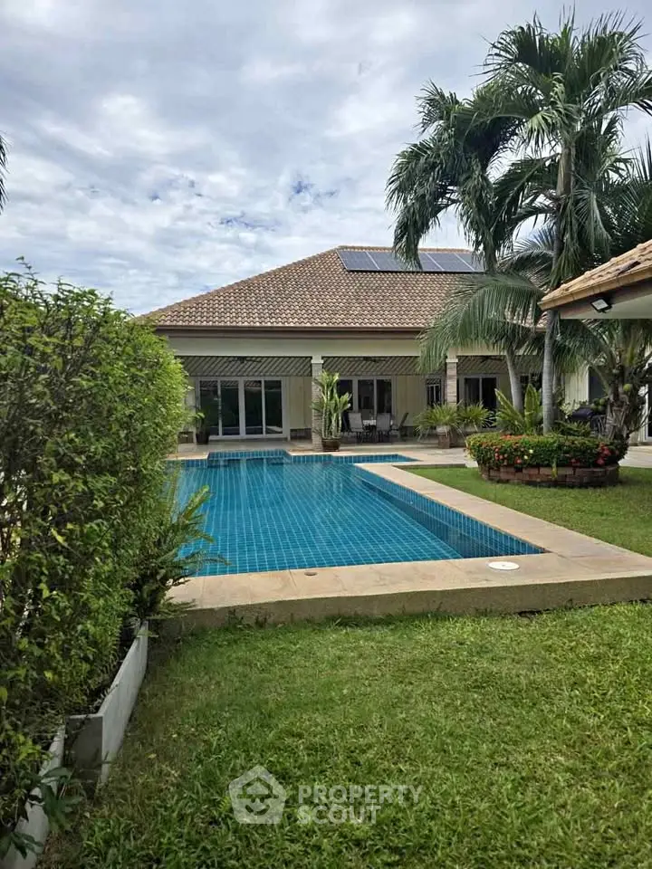 Luxurious villa with private pool and lush garden, perfect for tropical living.
