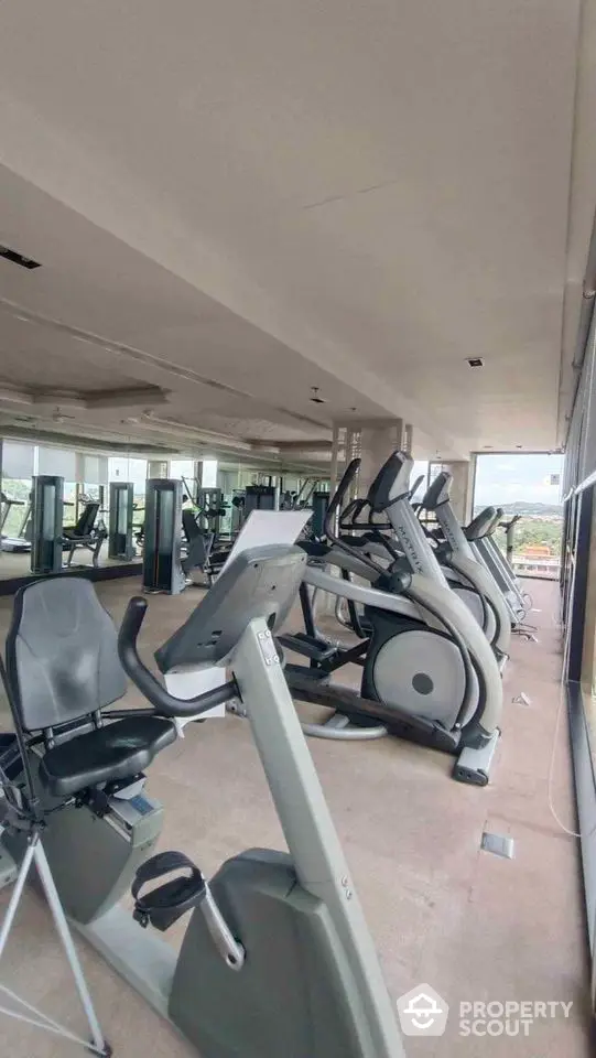 Spacious gym with modern exercise equipment and panoramic windows