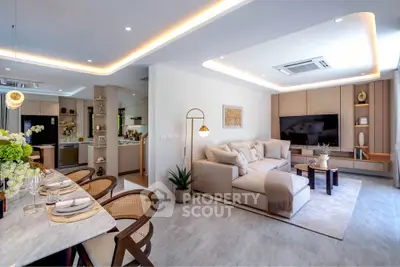 Luxurious open-plan living room with modern decor and elegant dining area, perfect for entertaining.