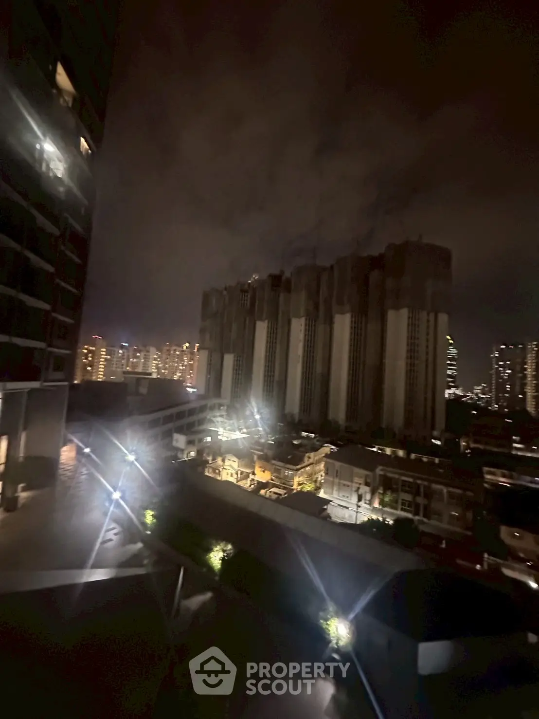 Nighttime cityscape view with illuminated buildings and skyline.