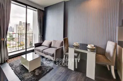 Modern living room with city view, featuring sleek furniture and floor-to-ceiling windows.