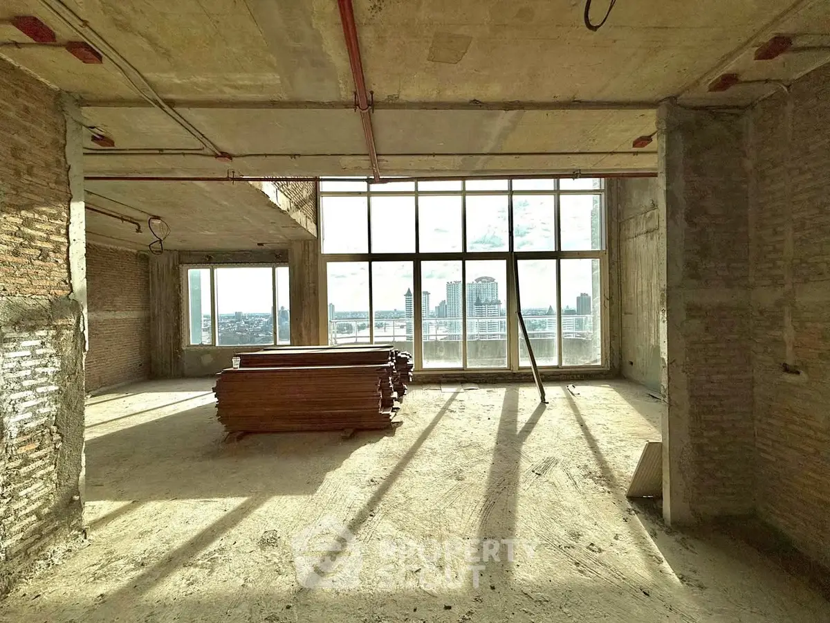 Spacious unfinished apartment with large windows and city view