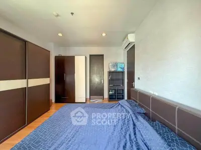 Spacious bedroom with modern furniture and ample storage space