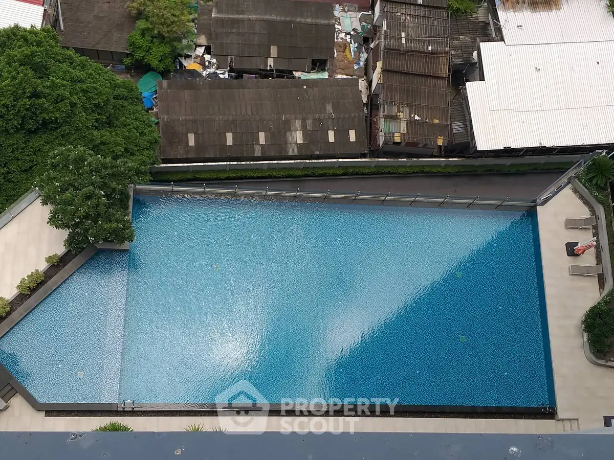 Stunning rooftop pool with panoramic city views and lush greenery, perfect for relaxation and leisure.