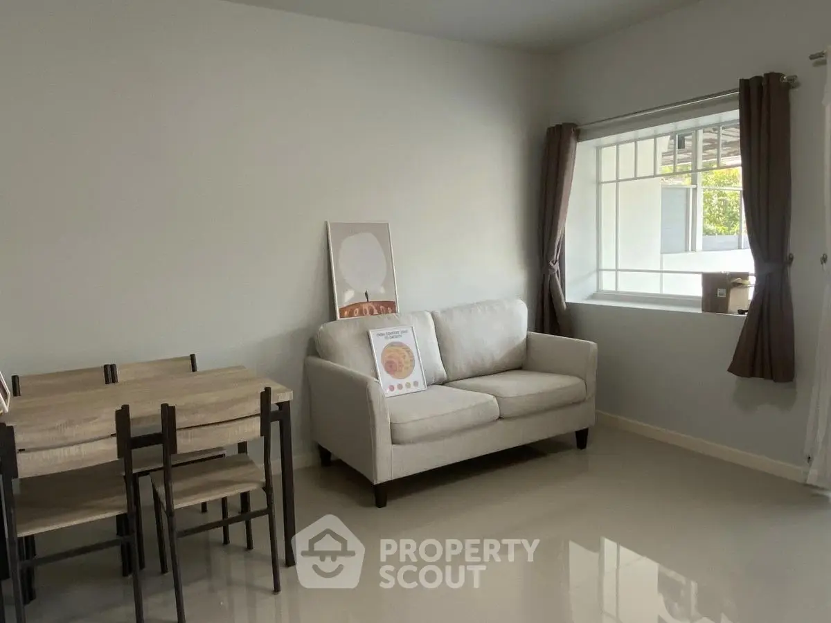 Cozy living room with modern furniture and large window for natural light