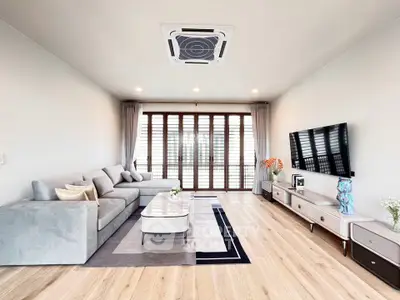 Spacious modern living room with elegant decor and large windows