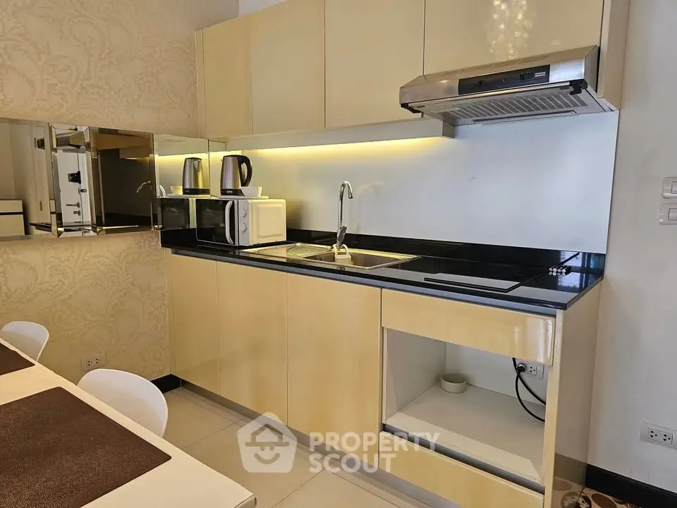 Modern kitchen with sleek cabinetry and integrated appliances in a stylish apartment.
