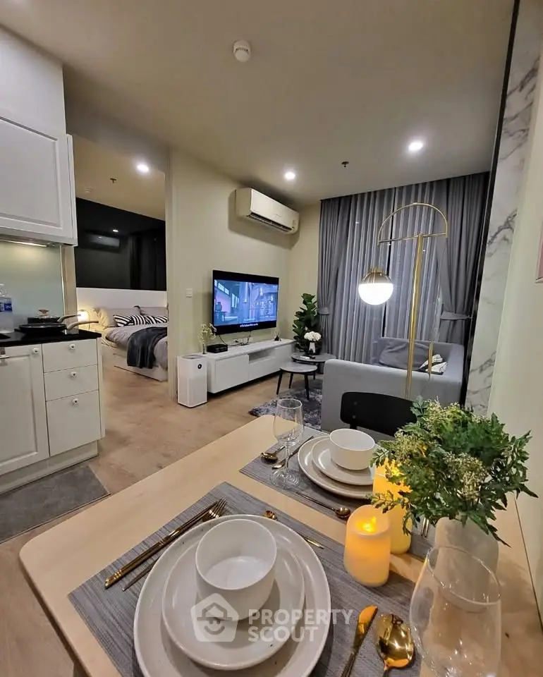 Modern open-plan living room and dining area with elegant decor and ambient lighting.