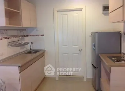 Modern kitchen with sleek cabinetry and stainless steel appliances in a compact layout.