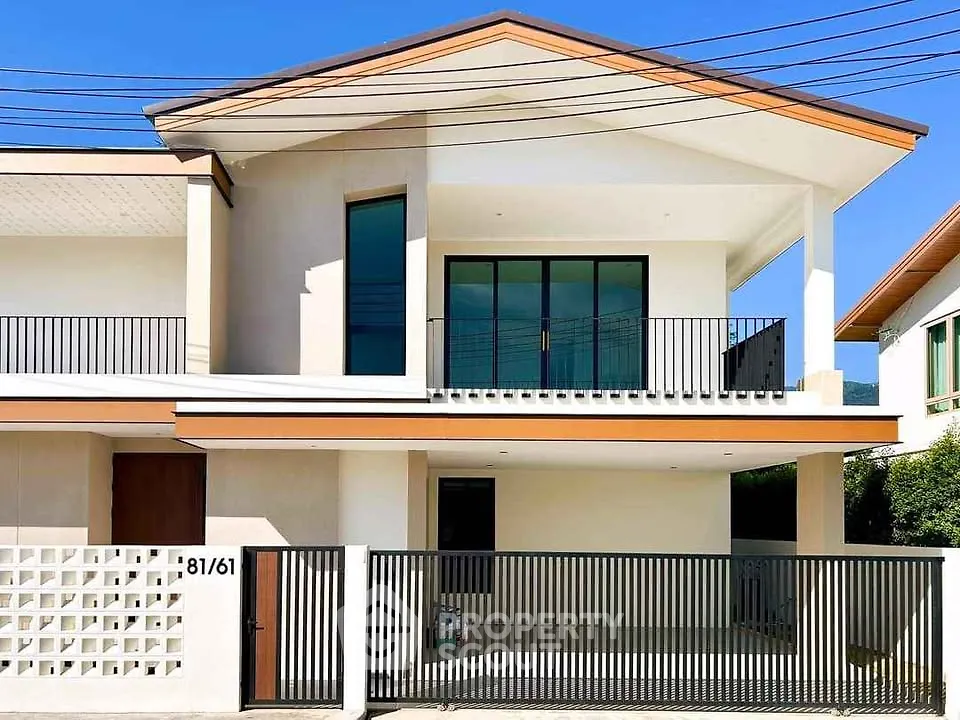 Modern two-story house with sleek balcony and gated entrance