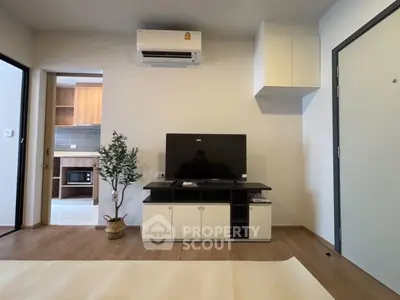 Modern living room with TV, air conditioner, and stylish decor