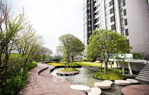 Luxurious modern building with serene landscaped garden and water features.