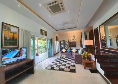 Spacious living room with modern decor and large balcony access